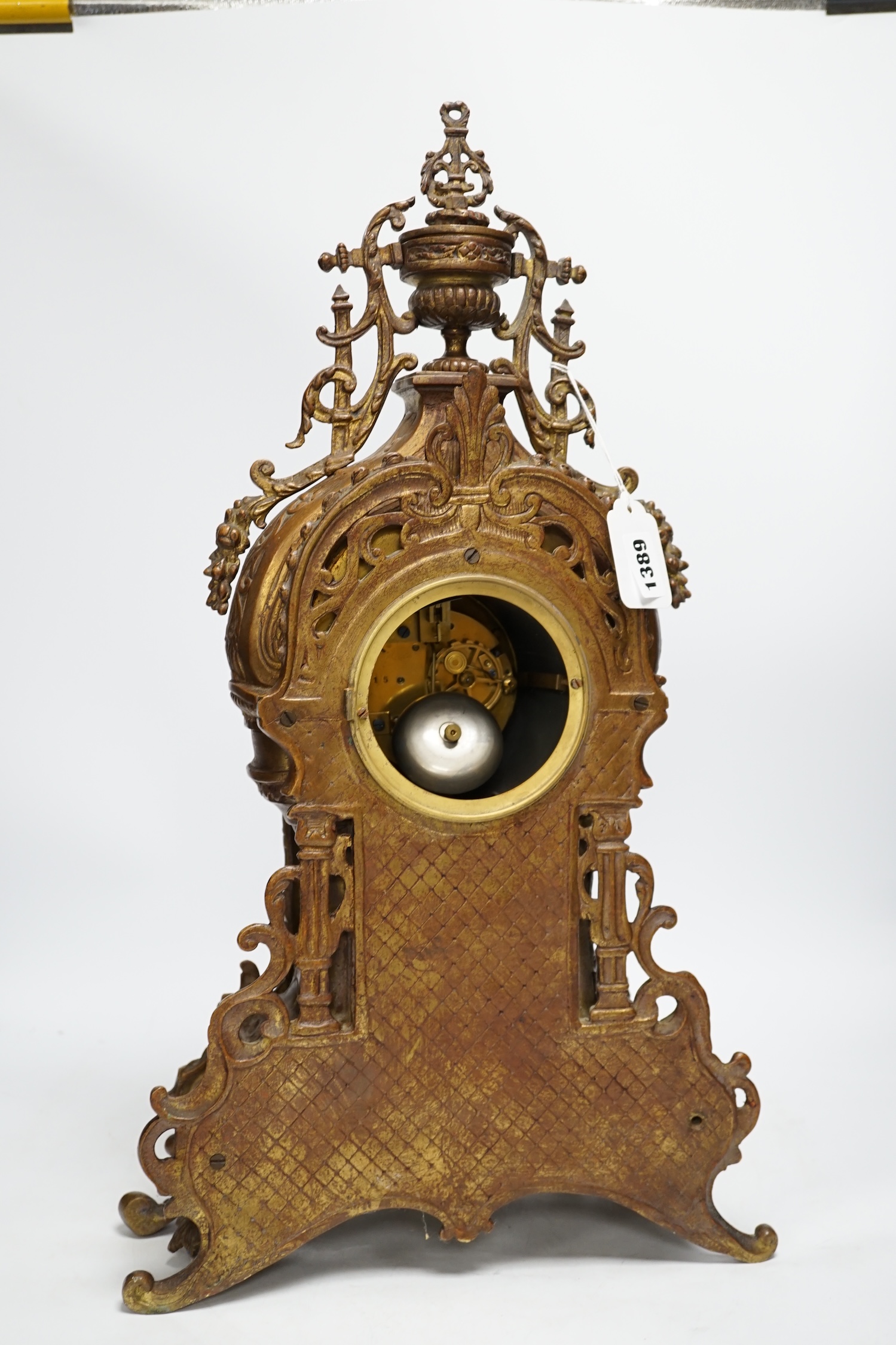 An ornately cast French bronze mantel clock, 57cm high